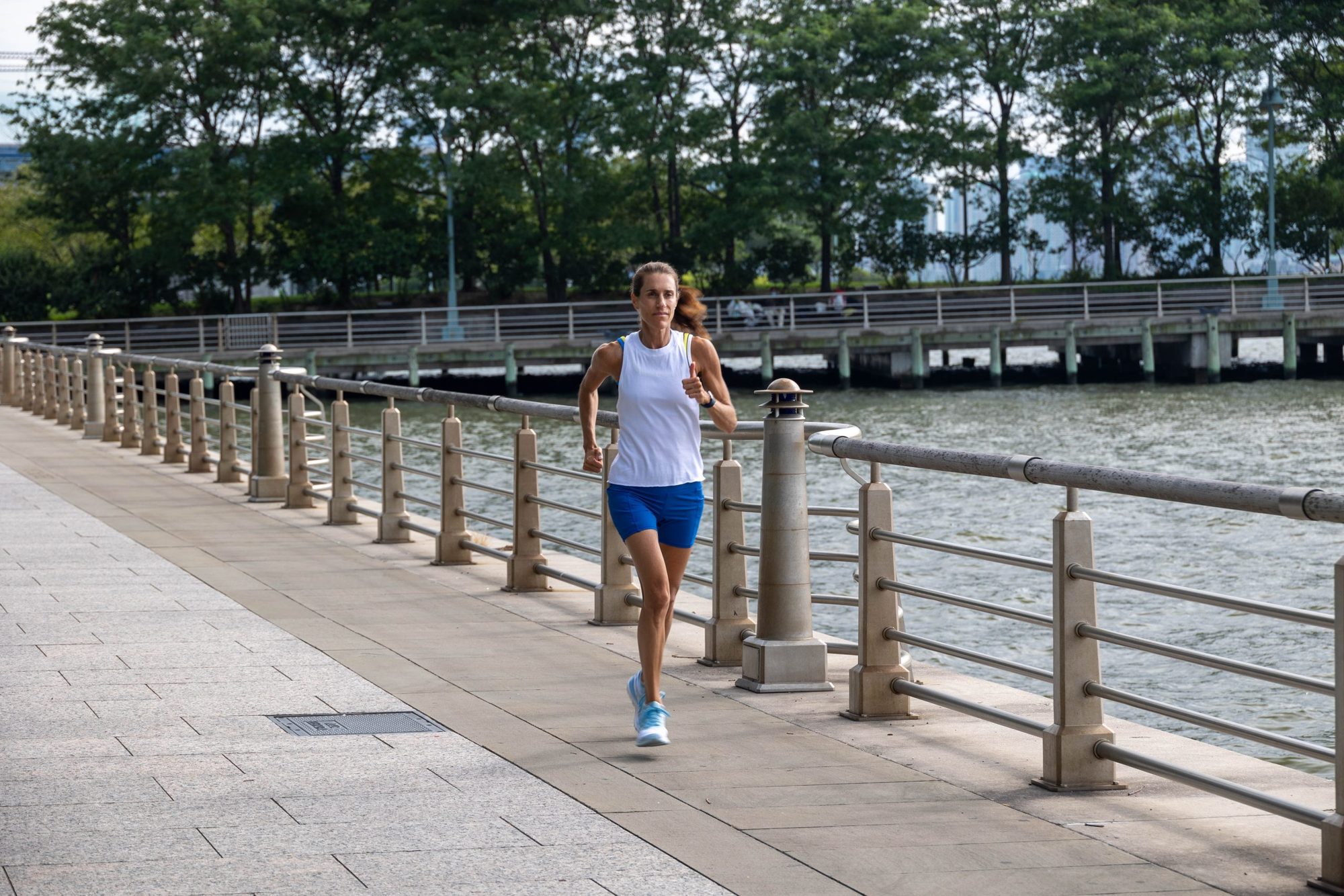 Samantha Gambino running along the Hudson River waterfront in New York City